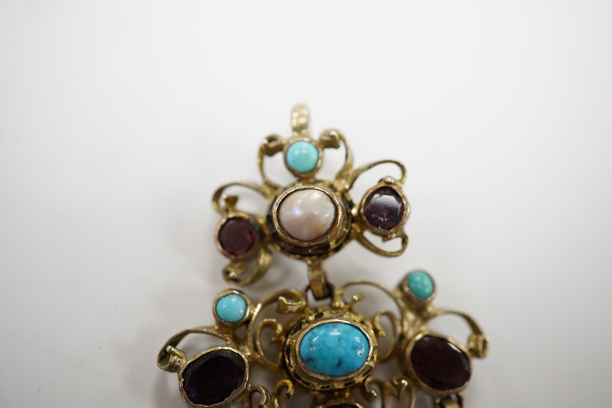 A 19th century Austro-Hungarian? gilt white metal, turquoise, garnet and split pearl set drop pendant, 53mm. Condition - poor to fair